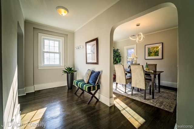 959 Washtenaw Rd, Ypsilanti, MI 48197 - dining room featuring arched walkways, ornamental molding, a chandelier, and dark wood finished floors
