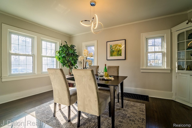959 Washtenaw Rd, Ypsilanti, MI 48197 - dining area with healthy amount of natural light, crown molding, dark wood finished floors, and a chandelier