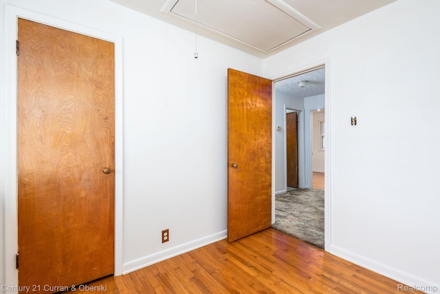 2548 Hearthside Dr, Ypsilanti, MI 48198 - spare room with attic access and wood finished floors
