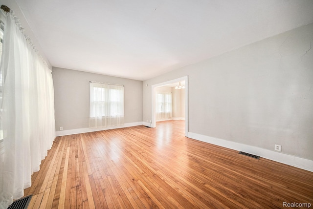 2904 Maplewood Ave, Ann Arbor, MI 48104 - unfurnished room featuring a chandelier and light wood-type flooring