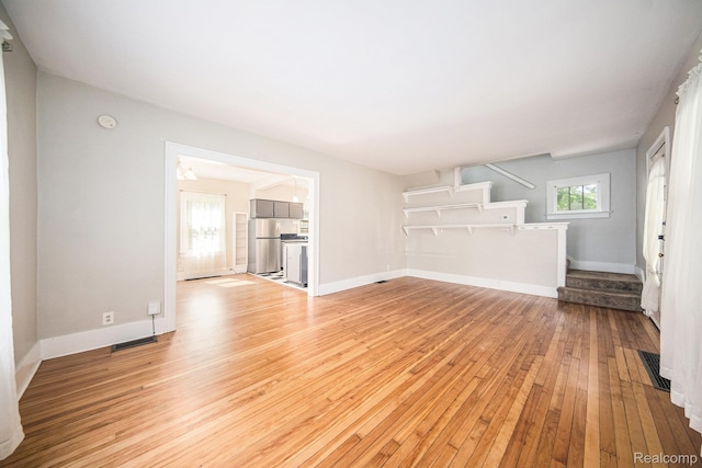 2904 Maplewood Ave, Ann Arbor, MI 48104 - unfurnished living room featuring stairway and light wood-style flooring