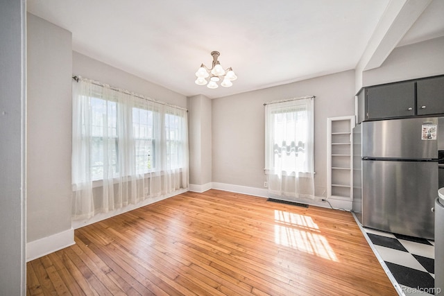 2904 Maplewood Ave, Ann Arbor, MI 48104 - unfurnished dining area with a chandelier and light wood finished floors