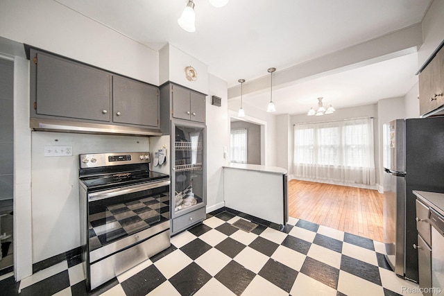 2904 Maplewood Ave, Ann Arbor, MI 48104 - kitchen featuring stainless steel appliances, gray cabinetry, dark flooring, a chandelier, and under cabinet range hood