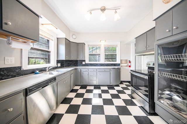 2904 Maplewood Ave, Ann Arbor, MI 48104 - kitchen with appliances with stainless steel finishes, gray cabinets, dark floors, and plenty of natural light