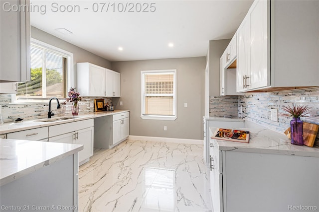 18024 Fairfield St, Redford, MI 48221 - kitchen featuring tasteful backsplash, light marble finish floors, recessed lighting, white cabinets, and light stone countertops