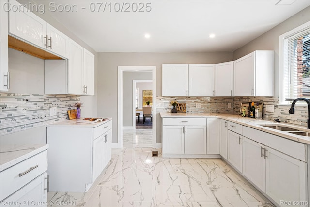 18024 Fairfield St, Redford, MI 48221 - kitchen featuring light marble finish flooring, decorative backsplash, recessed lighting, white cabinetry, and light stone counters