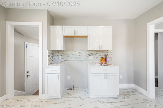 18024 Fairfield St, Redford, MI 48221 - kitchen featuring tasteful backsplash, light countertops, light marble finish flooring, and white cabinetry