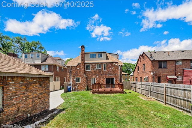 18024 Fairfield St, Redford, MI 48221 - back of property featuring a fenced backyard, a chimney, a wooden deck, a residential view, and brick siding