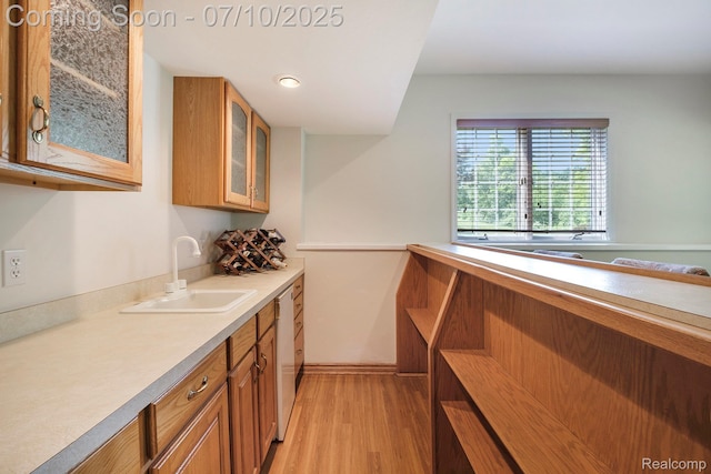 6161 Golfside Ct, Grand Blanc, MI 48439 - kitchen with brown cabinetry, light wood finished floors, glass insert cabinets, light countertops, and dishwasher
