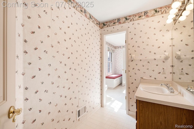 6161 Golfside Ct, Grand Blanc, MI 48439 - bathroom with wallpapered walls, vanity, tile patterned flooring, and a chandelier