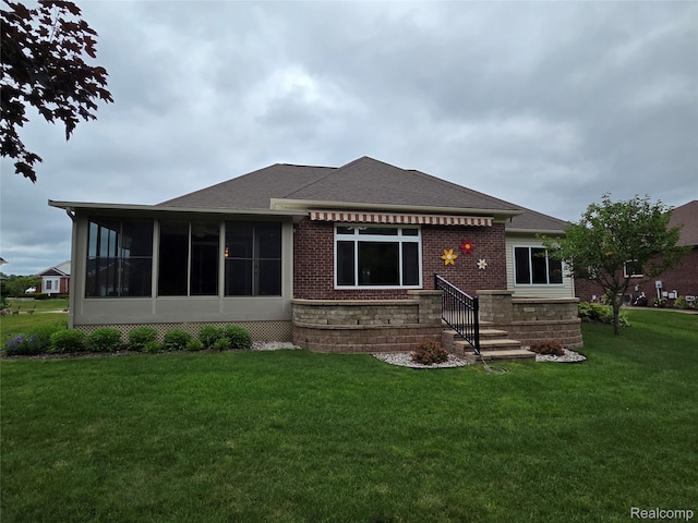 2181 E Shore Dr, Rochester Hills, MI 48307 - back of property with a shingled roof, a yard, a sunroom, brick siding, and entry steps