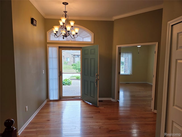2181 E Shore Dr, Rochester Hills, MI 48307 - entrance foyer with plenty of natural light, a chandelier, hardwood / wood-style floors, and crown molding