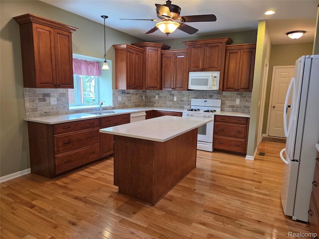 2181 E Shore Dr, Rochester Hills, MI 48307 - kitchen with white appliances, light countertops, decorative backsplash, ceiling fan, and light wood finished floors