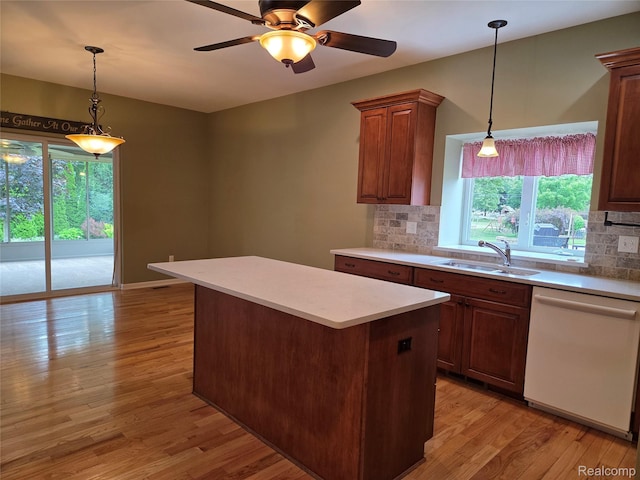 2181 E Shore Dr, Rochester Hills, MI 48307 - kitchen featuring dishwasher, tasteful backsplash, a kitchen island, light wood-style flooring, and light countertops