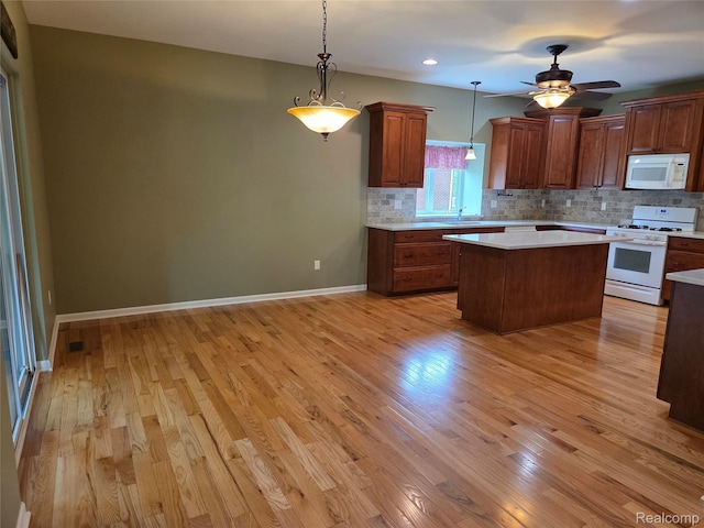 2181 E Shore Dr, Rochester Hills, MI 48307 - kitchen with white appliances, light countertops, backsplash, light wood-style flooring, and recessed lighting