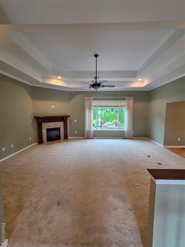 2181 E Shore Dr, Rochester Hills, MI 48307 - unfurnished living room with a tray ceiling, a ceiling fan, carpet floors, a high end fireplace, and recessed lighting