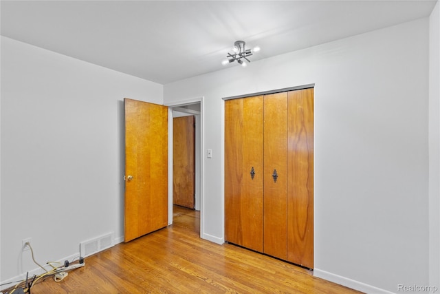 26714 Dover Ct, Warren, MI 48089 - unfurnished bedroom featuring a closet and light wood-style flooring