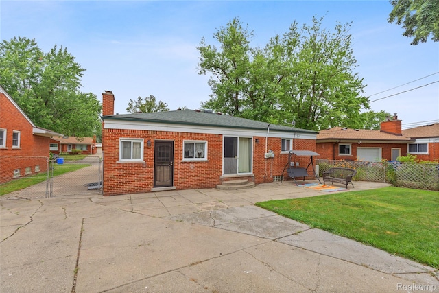 26714 Dover Ct, Warren, MI 48089 - back of house featuring entry steps, brick siding, a gate, a patio, and a chimney