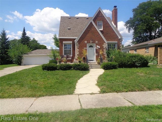1353 N Gulley Rd, Dearborn Heights, MI 48127 - tudor house featuring a chimney, a front lawn, brick siding, and roof with shingles