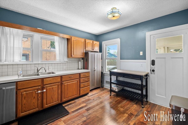 702 Griswold St SE, Grand Rapids, MI 49507 - kitchen with dishwasher, light countertops, wood finished floors, tasteful backsplash, and a textured ceiling