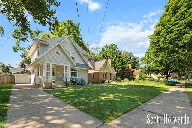 702 Griswold St SE, Grand Rapids, MI 49507 - view of front of property featuring a porch, an outdoor structure, a chimney, a detached garage, and a front lawn