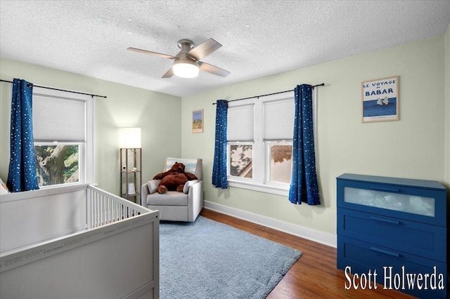 702 Griswold St SE, Grand Rapids, MI 49507 - bedroom featuring wood finished floors, a ceiling fan, and a textured ceiling