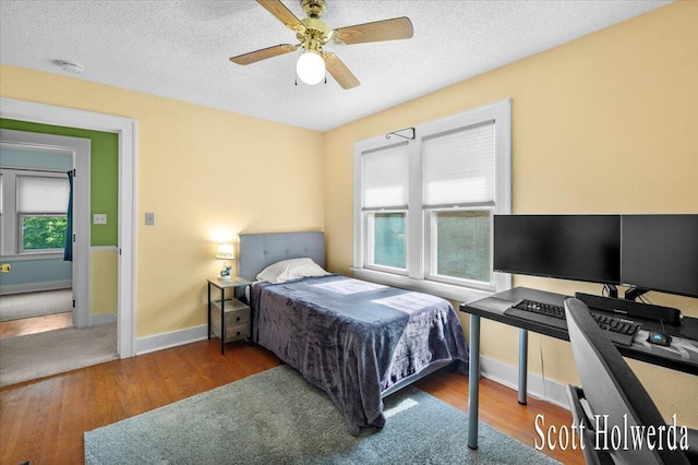 702 Griswold St SE, Grand Rapids, MI 49507 - bedroom featuring wood finished floors, a textured ceiling, and a ceiling fan