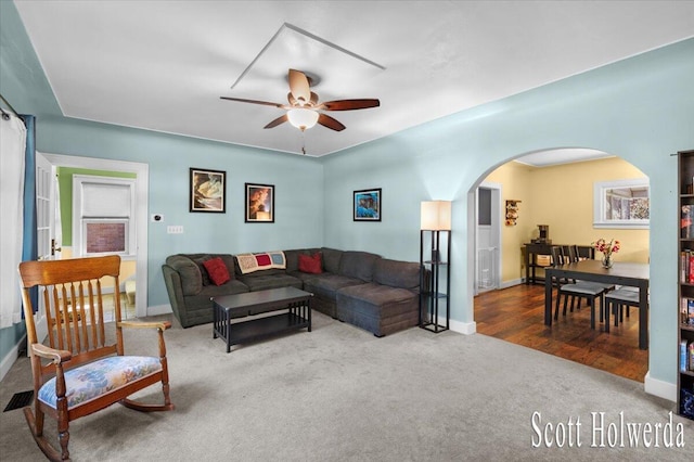 702 Griswold St SE, Grand Rapids, MI 49507 - living area with arched walkways, carpet flooring, and a ceiling fan