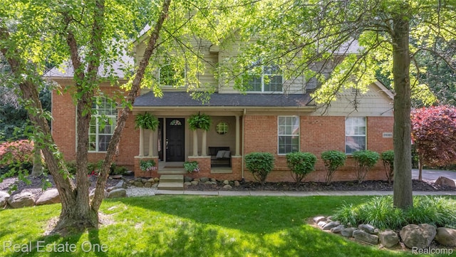 31085 Chatsford St, Novi, MI 48377 - view of front facade with a front lawn and brick siding