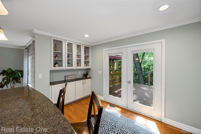 31085 Chatsford St, Novi, MI 48377 - dining area featuring french doors, ornamental molding, wood finished floors, and recessed lighting