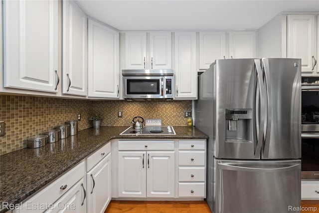31085 Chatsford St, Novi, MI 48377 - kitchen with stainless steel appliances, white cabinets, tasteful backsplash, dark stone countertops, and light wood-type flooring