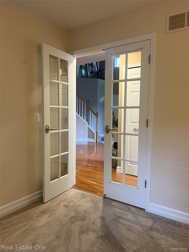 31085 Chatsford St, Novi, MI 48377 - doorway to outside featuring stairway, french doors, and carpet flooring