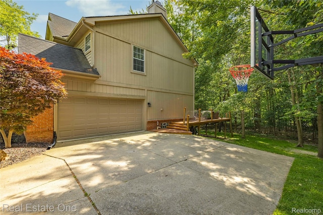 31085 Chatsford St, Novi, MI 48377 - view of home's exterior with a garage, roof with shingles, driveway, and a chimney