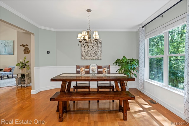 31085 Chatsford St, Novi, MI 48377 - dining area with light wood-type flooring, a chandelier, ornamental molding, and wainscoting