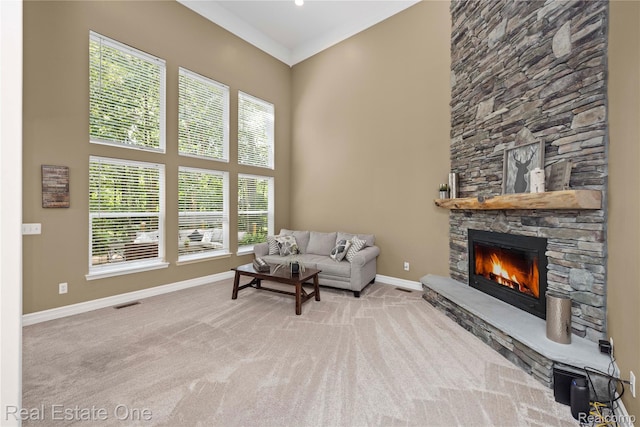 31085 Chatsford St, Novi, MI 48377 - living area featuring carpet floors, a fireplace, and a towering ceiling