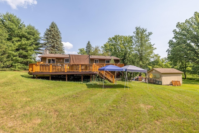 19744 Ivey Rd, Chelsea, MI 48118 - rear view of property with a deck, a yard, a chimney, a storage shed, and stairway