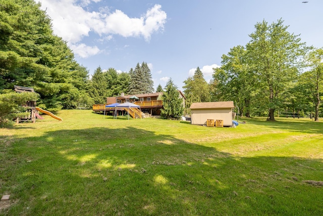 19744 Ivey Rd, Chelsea, MI 48118 - view of green lawn featuring a wooden deck, a shed, stairway, and a playground