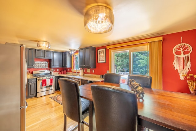 19744 Ivey Rd, Chelsea, MI 48118 - dining space with a chandelier and light wood finished floors