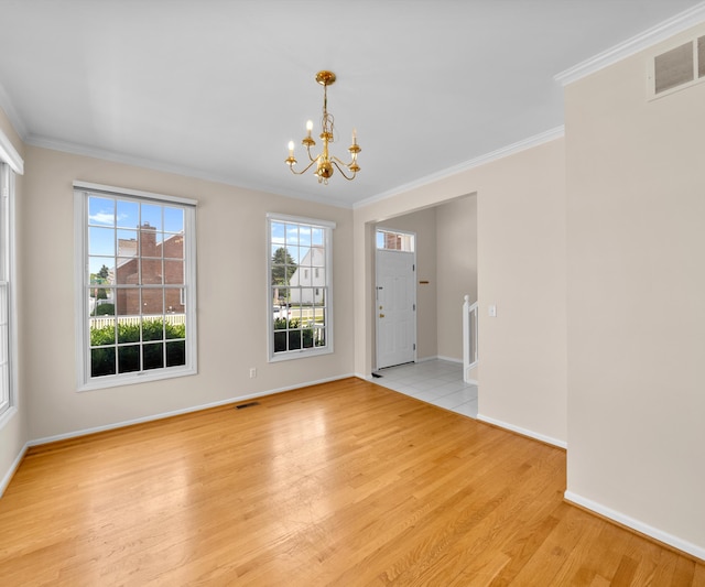 668 Boston Ct, Ann Arbor, MI 48103 - foyer entrance with a chandelier, crown molding, and light wood finished floors