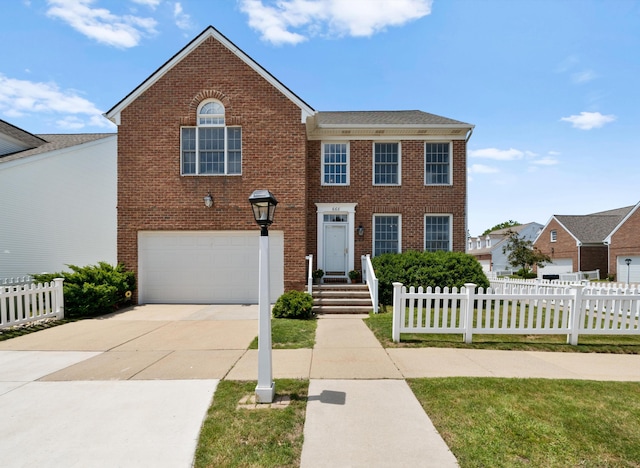 668 Boston Ct, Ann Arbor, MI 48103 - view of front of property with an attached garage, brick siding, and driveway