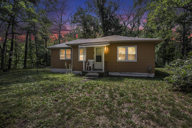 565 E Rockford Rd, Idlewild, MI 49642 - bungalow featuring a lawn
