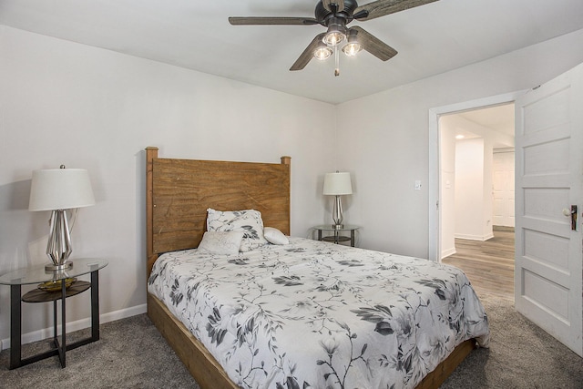 565 E Rockford Rd, Idlewild, MI 49642 - carpeted bedroom featuring baseboards and a ceiling fan