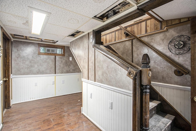565 E Rockford Rd, Idlewild, MI 49642 - finished basement featuring wood finished floors, wainscoting, and a drop ceiling