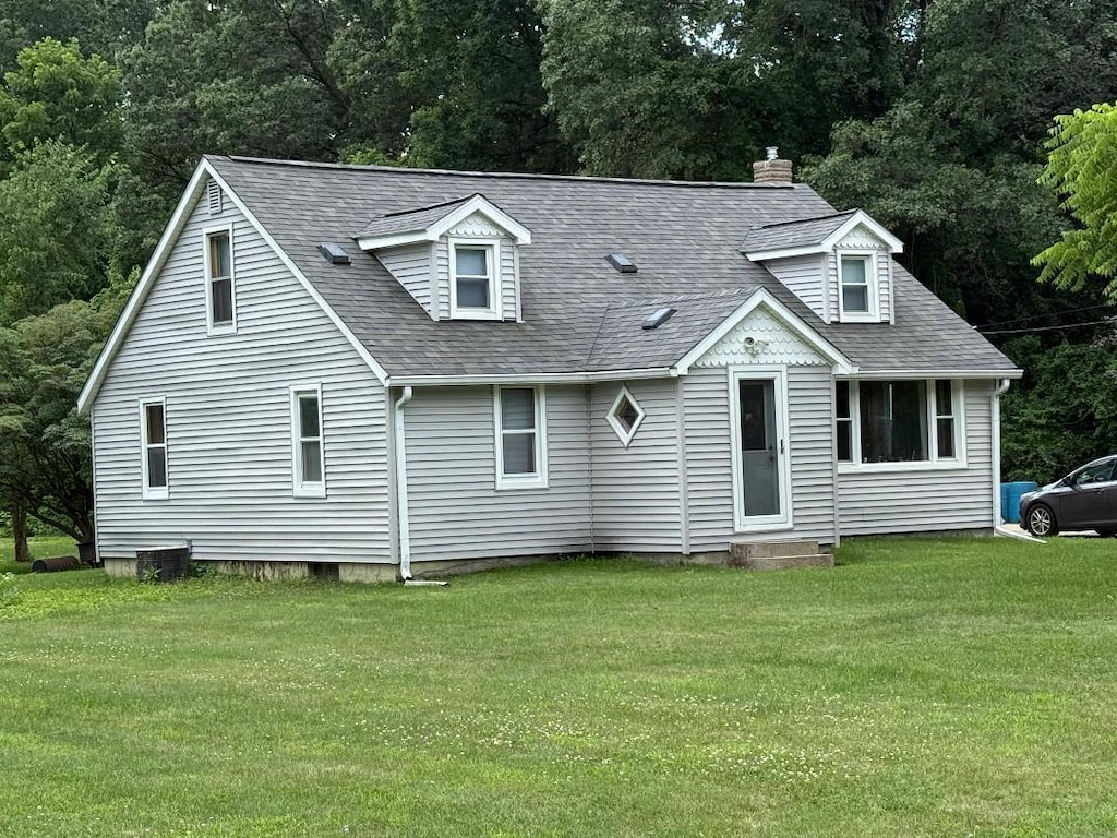 226 Poulsen Ave, Battle Creek, MI 49014 - view of front of house with a front lawn, roof with shingles, and a chimney