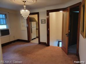 17951 Prospect St, Dearborn Heights, MI 48122 - unfurnished dining area with carpet and a chandelier