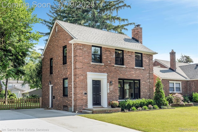 2182 Hawthorne Rd, Detroit, MI 48236 - view of front facade with a shingled roof, a chimney, and brick siding