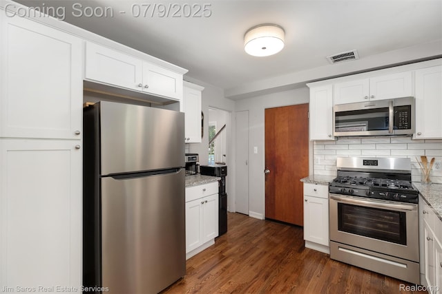 2182 Hawthorne Rd, Detroit, MI 48236 - kitchen featuring appliances with stainless steel finishes, tasteful backsplash, light stone counters, and white cabinetry