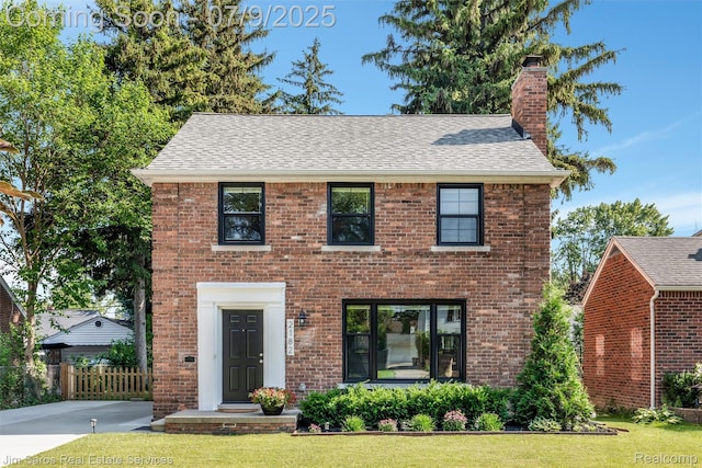 2182 Hawthorne Rd, Detroit, MI 48236 - view of front of house with a chimney, brick siding, and a shingled roof