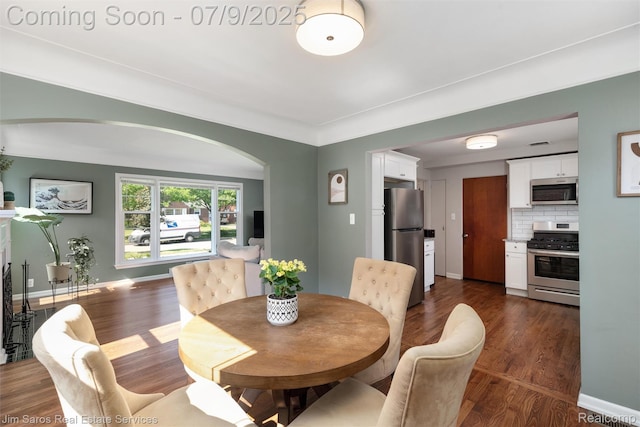 2182 Hawthorne Rd, Detroit, MI 48236 - dining space featuring arched walkways and dark wood-type flooring