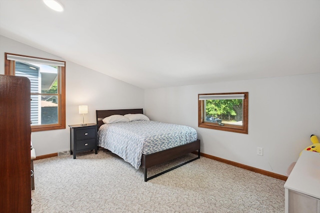 5090 Schrah Dr, Munith, MI 49259 - carpeted bedroom featuring lofted ceiling and baseboards